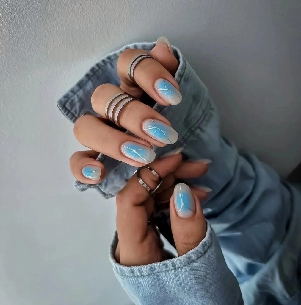 Blue Aura Nails with White Marble Detail: This Season’s Ethereal Trend